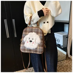 Close-up of a brown plaid tote bag featuring a cute white plush puppy embroidery detail