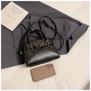 Detailed top view of retro doctor style handbag with gold hardware and shoulder strap
