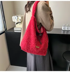 Detail of red plush bucket bag showing soft texture and checkered lining detail