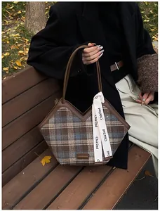 Detail of plaid fabric tote bag with V-cut opening and fashion ribbon accessory