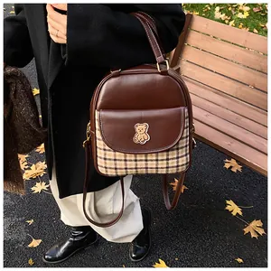 Stylish brown ladies backpack with checkered plaid pocket and cute teddy bear detail