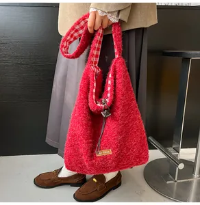 Detail of red plush tote bag with soft faux fur texture and red white checkered lining