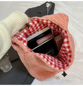 Interior detail of pink plush bucket bag showing large capacity and checkered lining