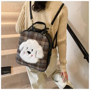 Macro view of plaid pattern fabric and plush puppy embroidery on a casual tote bag