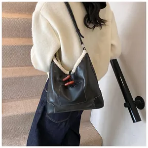 Detailed view of retro black shoulder bag with white faux fur trim and toggle closure