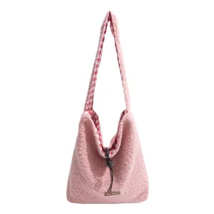 Pink faux shearling crossbody bucket bag with plush texture and red checkered lining
