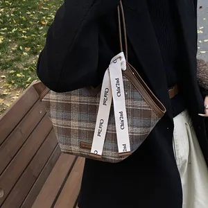 Retro plaid tote bag with brown faux leather trim and woven decorative straps