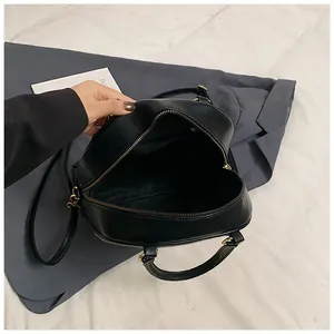 Detail of spacious interior with side zipper pocket in black large tote bag