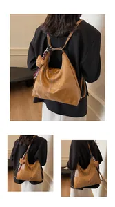 Detail of brown vintage tote bag showing retro faux leather texture and contrast stitching