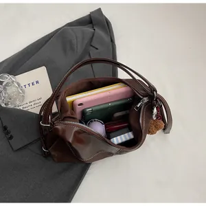Spacious interior of dark brown tote bag holding a tablet, notebook and daily essentials