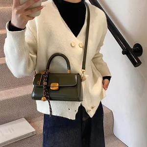 Vintage dark green glossy leather crossbody bag with golden square lock and woven strap