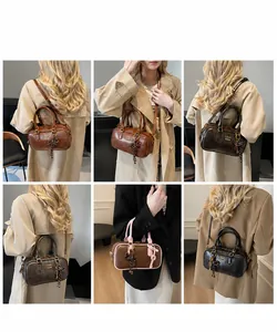 Detailed view of vintage Boston bags in multiple colors featuring tassel charms and top handles