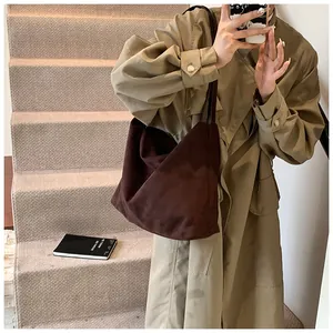 Detailed view of the dark brown suede texture on a minimalist large tote bag for women