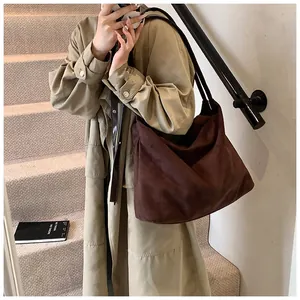 Coffee brown suede tote bag shown on model with vintage aesthetic and large capacity