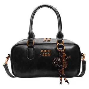 Retro black Boston handbag with gold hardware and stylish detachable shoulder strap