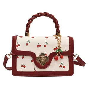 Elegant off-white cherry print handbag with red woven handle and gold flower lock
