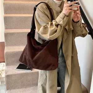 Minimalist large brown suede tote bag for women shown as a stylish shoulder bag