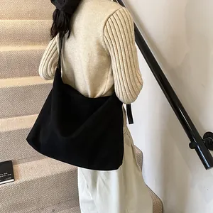 Large black suede tote bag with a minimalist half-moon shape for daily casual wear
