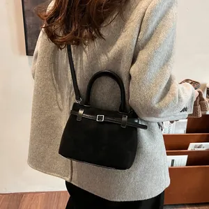Black matte leather crossbody tote bag for women shown from a stylish rear angle