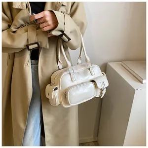 Retro cream bowling bag detail showing multiple pockets and smooth synthetic leather