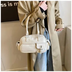 Detail of off-white glossy bowling bag with functional pockets on trench coat