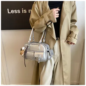 Detail of silver metallic bowling bag with functional pockets and creative charms