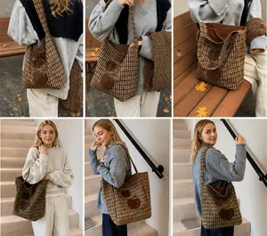 Detailopnames van een wollen houndstooth shopper met appelborduurwerk gedragen door een model