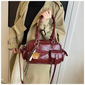Close-up of vintage burgundy bowling bag with functional pockets and a piglet charm