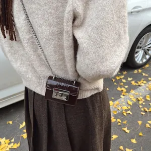 Micro dark brown patent leather crossbody chain bag with silver buckle in street style