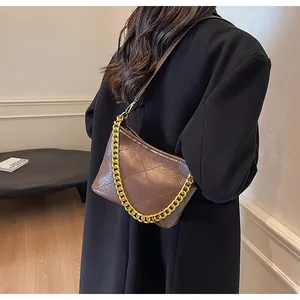 Detail der braunen gesteppten Beuteltasche mit Goldkette und Rautensteppung