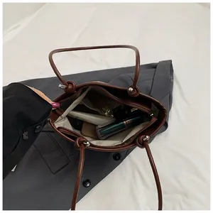 Internal view of large capacity brown tote bag showing spacious room for cosmetics and wallet