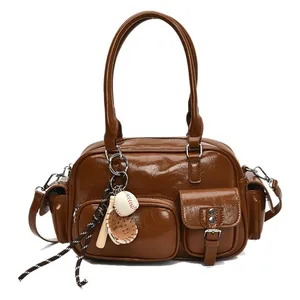 Vintage brown leather bowling tote bag with baseball charms and adjustable strap