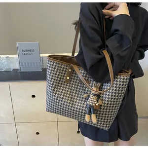 Classic houndstooth tote bag with brown leather trim and cute rabbit doll keychain charm