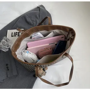 Top view of houndstooth tote bag interior showing large capacity and organized pockets