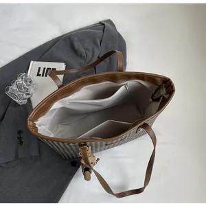 Top view of houndstooth tote bag interior with zipper pocket and beige lining