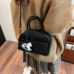 Chic black matte leather Boston bag for women with cute pony charm on shoulder strap
