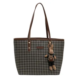 Chic houndstooth tote bag for women with brown leather trim and a cute plush bunny pendant
