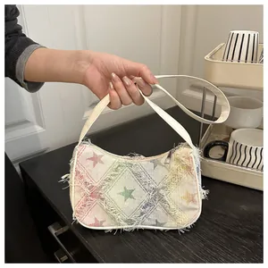 Detail of the chic rainbow gradient checkered fabric and star pattern on the shoulder bag