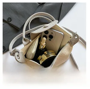 Internal capacity of beige faux crocodile leather bag with phone and cosmetics