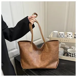 Detailed macro view of caramel brown tote bag with premium lychee grain leather texture