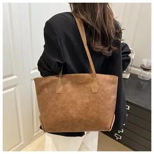 Brown vintage faux leather tote bag shown on shoulder for daily office commuting style