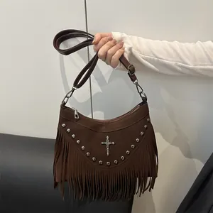 Brown suede crossbody bag with fringe tassels, rivets and a silver gothic cross accent