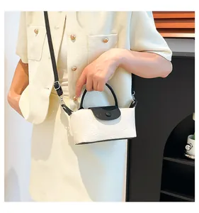 Detail of small crossbody bag with black and white contrast and geometric embossing