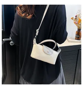 Detail of retro embossed texture on mini flap square bag with cream grey contrast