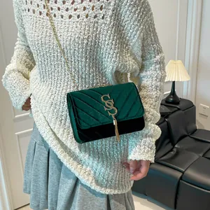 Sac bandoulière en velours vert foncé avec surpiqûres en V et pampille dorée