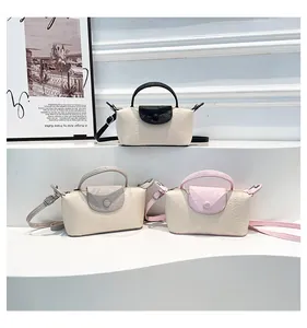 Detailed macro view of three textured mini dumpling handbags in assorted pastel colors
