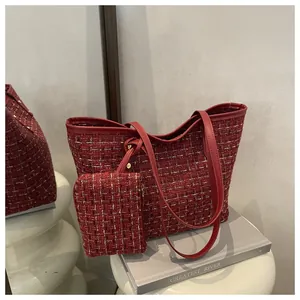 Détail du sac cabas en tweed rouge avec pochette assortie et bordures en cuir élégantes