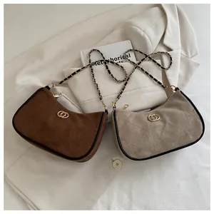 Detail of rhombic quilted matte leather bags with gold buckle and chain straps