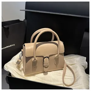 Close-up of a cream leather handbag in a luxury gift box with silk lining