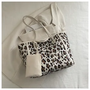 Detailed top view of leopard print canvas tote bag with matching mini pouch accessory